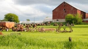 Sell Business A farm with old tractors and a red barn is available for sale. Exit Advisor Business Broker