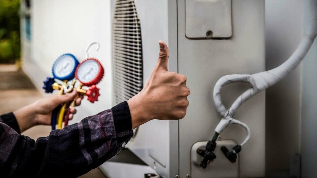 Sell Business A man giving a thumbs up to an air conditioner, endorsing its quality in his HVAC business. Exit Advisor Business Broker