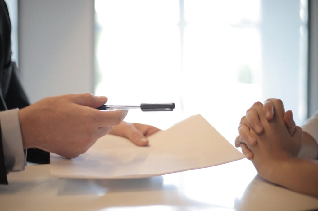 How to Sell Your Legal Practice. Sell Business A man in a suit is handing a premium exit document to a woman. Exit Advisor Business Broker