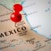 Mexico's Real Estate Market Trends for Foreign Investors - Sell Business Red pushpin on a map emphasizing Mexico Real Estate, with visible city names and borders. Exit Advisor Business Broker