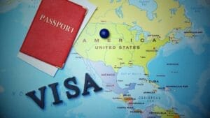 EB5 Visa Guide for Aspiring Business Owners: Start Here! - Sell Business A red passport and blue "EB5 Visa" letters lying on a map focused on the United States, with a blue pin marking the country. Exit Advisor Business Broker